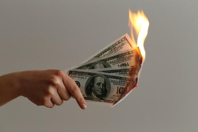 burning money in hand
